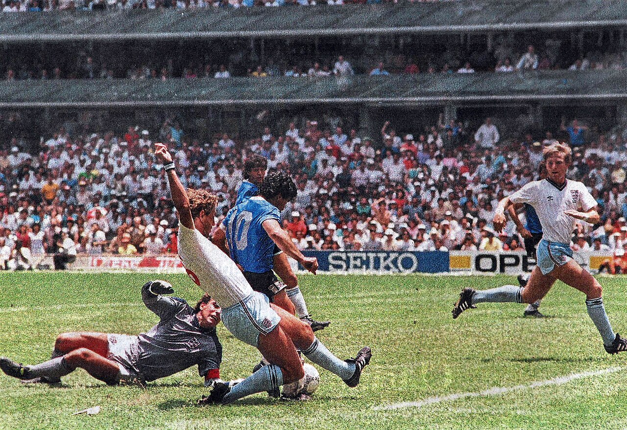 Diego Maradona evades England's goalkeeper and defender during his second goal in the 1986 World Cup quarterfinal.