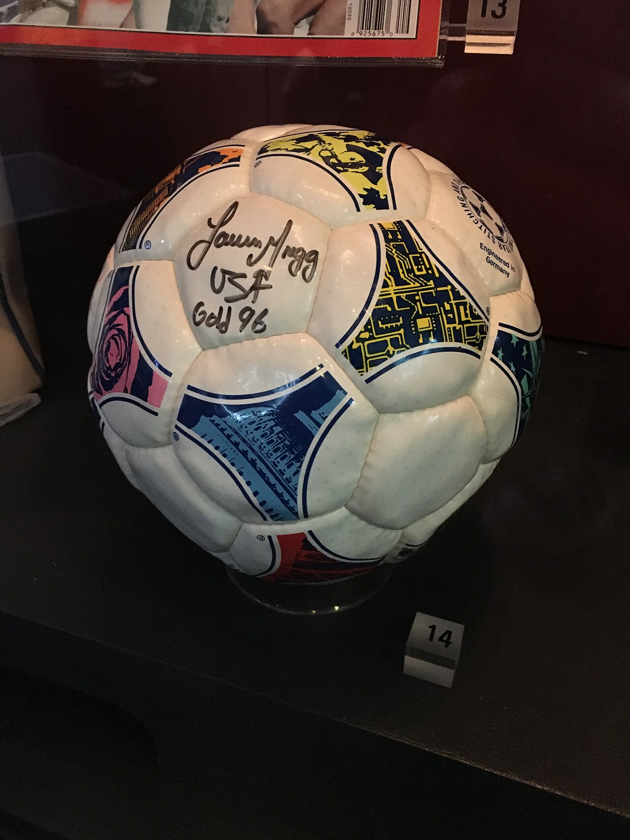 A 1999 Women's World Cup match ball signed by members of the winning United States team, displayed in a museum.